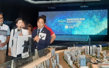 <p><strong>BUSAN 2030.</strong> Busan Metropolitan City Overseas Expo Outreach Division director Hwang Hyun-ki (right) explains the port redevelopment project in Busan, the city which South Korea has chosen to host the World Expo 2030, in an interview Sunday (Sept. 24, 2023). The port city is up against Rome, Italy and Riyadh, Saudi Arabia in the hosting bid. <em>(PNA photo by Kris Crismundo)</em></p>