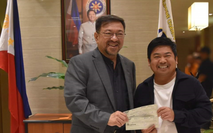 <p><strong>CHARITY FUND.</strong> Philippine Charity Sweepstakes Office general manager Melquiades Robles (left) hands over checks worth PHP13 million to Caloocan Mayor Dale Malapitan at the PCSO main office in Mandaluyong City on Sept. 14, 2023. Malapitan said the funds will be used to augment the city’s charity and health programs. <em>(Photo courtesy of PCSO)</em></p>