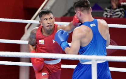 <p><strong>VICIOUS</strong>. The Philippines’ Eumir Marcial sends a left to Dalai Gadzorig of Mongolia in their men’s 80 kg class bout at the start of the boxing competitions in the 19th Asian Games in Hangzhou, China on Monday (Sept. 25, 2023). Marcial scored a 5-0 victory to advance to the Round of 16. <em>(Photo courtesy of PSC-POC Media Group)</em></p>
