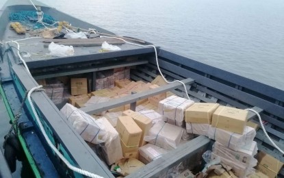 <p><strong>CONTRABAND.</strong> Task Force Davao (TFD) operatives seize PHP28.8 million worth of smuggled cigarettes at Minterbro Wharf, Barangay Ilang, Davao City on Monday (Sept. 25, 2023). Thirteen persons onboard a boat carrying the contraband were arrested by authorities. <em>(Photo courtesy of Task Force Davao)</em></p>