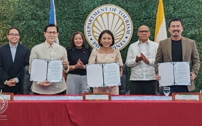 <p><strong>MOA SIGNING.</strong> Tourism Secretary Christina Garcia Frasco (middle), TIEZA COO Mark Lapid (right) and FDCP Chair and CEO Tirso Cruz III (2nd from left) sign a memorandum of agreement allowing the construction of a film heritage building in Intramuros on Wednesday (Sept. 27, 2023). The film heritage building will occupy an 800 sqm.-lot along Sta. Lucia Street and will be designed to house a cinematheque, film museum/gallery, film and media library, film storage/vaults and film scanning and restoration room. <em>(Photo courtesy of DOT)</em></p>