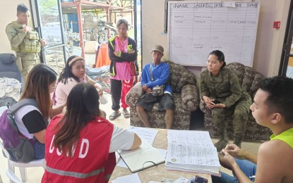 <p><strong>GOV’T AID</strong>. 1Lt. Charmaine Sancho (2nd from right), civil-military operations officer of the 47th Infantry Battalion, helps family members of the slain New People’s Army fighters during the release of the cash assistance by the Department of Social Welfare and Development at Kabankalan City Social Development Welfare Office on Monday (Sept. 25, 2023). Six communist rebels died in a clash with government troops in the hinterlands of Kabankalan City, Negros Occidental on Sept. 21 . (<em>PNA photo courtesy of 47th Infantry Battalion, Philippine Army</em>)</p>
<p> </p>
<p> </p>