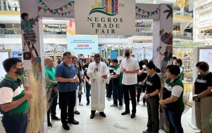 <p><strong>TRADE FAIR.</strong> Negros Occidental Governor Eugenio Jose Lacson (4th from right) leads the official opening and blessing of the booths of the 37th Negros Trade Fair with chairperson Michael Claparols (3rd from left) and Association of Negros Producers president Arlene Infante (3rd from right) at the Glorietta Activity Center in Makati City on Wednesday (Sept. 27, 2023). The country’s longest-running provincial trade fair, which sells Negrense-made food products, crafts, fashion, and homestyle items, will run until Oct. 1. (<em>PNA Photo courtesy of PIO Negros Occidental</em>)</p>