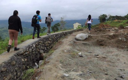 <p><strong>OUTREACH.</strong> Members of the DOST Scholars' Association of Negros Oriental (DOST SA NegOr) trek on rough road for an outreach program at Pacuan National High School-Busilak Extension in La Libertad, Negros Oriental in this undated photo. The DOST SA NegOr was named best scholarship association in Central Visayas this year. (<em>Photo courtesy of DOST SA NegOr)</em></p>