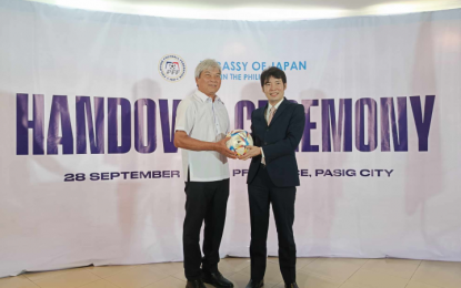 <p><strong>JAPAN DONATION.</strong> Philippine Football Federation (PFF) president Nonong Araneta receives a football from Embassy of Japan First Secretary Shigehiro Matsuda during a handover ceremony at the PFF office in Pasig on Thursday (Sept. 28, 2023). The PFF received a donation of practice jerseys and footballs from Japan embassy. <em>(PNA photo by Ivan Stewart Saldajeno)</em></p>