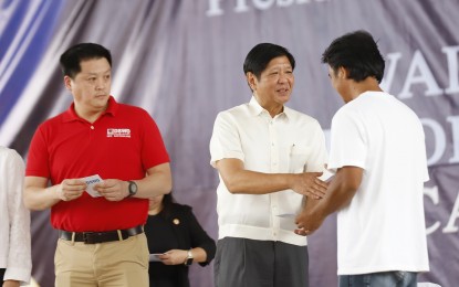 <p><strong>FOOD STAMP PROGRAM.</strong> President Ferdinand R. Marcos Jr. (center) and Department of Social Welfare and Development Secretary Rex Gatchalian (left) lead the distribution of the Electronic Benefit Transfer (EBT) cards during the kickoff of the flagship "Walang Gutom 2027: Food Stamp Program" in the Caraga Region, held in Siargao Island, Surigao del Norte on Sept. 29, 2023. Gatchalian said Thursday (Nov. 2, 2023) that the FSP is one of the innovative programs of the government to combat and end hunger and poverty in the country. <em>(PNA photo by Alfred Frias)</em></p>
