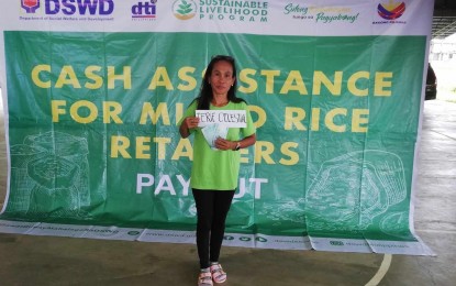<p><strong>SUBSIDY.</strong> Rice retailer Terie Celestial shows the PHP15,000 subsidy she receives on Thursday (Sept. 28, 2023). Department of Social Welfare and Development Sustainable Livelihood Program Antique provincial team leader Noli Valenzuela said in an interview Friday (Sept. 29, 2023) they had already released economic recovery subsidies to a total of 339 rice retailers in the province as of Sept. 28. (<em>PNA photo by Annabel Consuelo J. Petinglay</em>)</p>