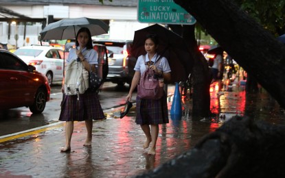 <p><strong>RAIN SHOWERS.</strong> Pedestrians wade through the flooded corner of Taft and United Nations Avenues in Manila on Sept. 28, 2023. A low-pressure area last tracked 1,415 kilometers east of Eastern Visayas is forecast to enter the Philippine Area of Responsibility in 24 to 48 hours, the weather bureau said Monday (Oct. 9, 2023).<em> (PNA photo by Joan Bondoc)</em></p>