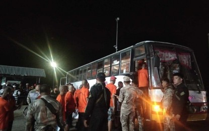 <p><strong>NEW HOME.</strong> A total of 450 inmates from the New Bilibid Prison and Correctional Institution for Women arrive in Puerto Princesa, Palawan by boat on Sunday night (Oct. 1, 2023). They were transferred to the Iwahig Prison and Penal Farm to decongest prison facilities in the National Capital Region. (PNA photo by Izza Reynoso)</p>