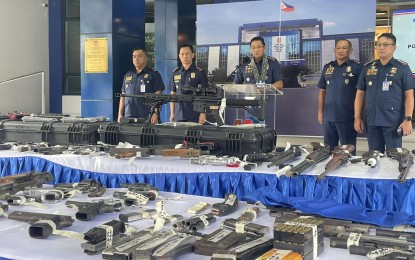 <p><strong>LOOSE GUNS.</strong> PNP chief Gen. Benjamin Acorda Jr. (in rostrum) and other police officials present to the media some 53 unlicensed firearms at Camp Crame, Quezon City on Monday (Oct. 2, 2023). Members of the CIDG seized the guns and nabbed a dealer during a search warrant operation in Marikina City on Sept. 29. <em>(PNA photo by Lloyd Caliwan)</em></p>