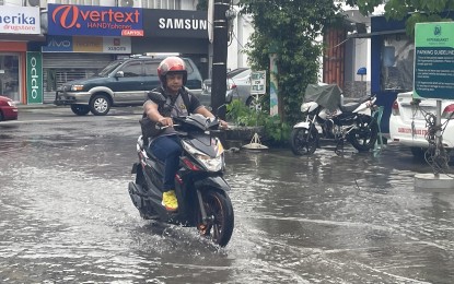 <p><strong>FLOODWATERS</strong>. A motorist makes his way through floodwaters along Paco Roman St. in Laoag City, Ilocos Norte on Monday (Oct. 2, 2023). Portions of the province are under Tropical Cyclone Wind Signal No. 1 as Typhoon Jenny intensifies. <em>(PNA photo by Leilanie Adriano)</em></p>