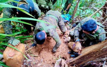 <p><strong>FOOD CACHE.</strong>  Soldiers unearth a food cache buried by rebels in San Isidro village in Las Navas, Northern Samar, in this Oct. 2, 2023 photo. The military thanks former supporters of the New People's Army for disclosing the location of the buried cache that led the rebels to crisis. (<em>PNA photo courtesy of Philippine Army</em>)</p>