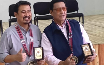 <p><strong>FATHER AND SON</strong>. Tourism Infrastructure and Enterprise Zone Authority (TIEZA) chief operating officer Mark Lapid and his father, Sen. Lito Lapid, pose with the tokens from the city government given on Monday (Oct. 9, 2023) during the awarding of cash aid funded by the office of Sen. Lapid for 533 individuals. The younger Lapid said TIEZA remains committed to helping in the rehabilitation of Burnham Park. Before the pandemic hit, TIEZA’s Board approved a PHP400-million funding for the rehabilitation of one of Baguio City’s tourism spot. <em>(PNA photo by Liza T. Agoot)</em></p>