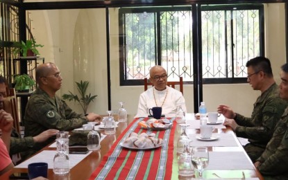 <p><strong>COLLABORATION</strong>. Bishop Gerardo Alminaza (center) of the Diocese of San Carlos in Negros Occidental meets with Philippine Army officials led by Maj. Gen. Marion Sison (right), commander of 3rd Infantry Division, during a courtesy visit at the Bishop’s Home in San Carlos City, Negros Occidental on Sunday (Oct. 8, 2023). “I want to collaborate. I want it to be clear: I am not in favor of violence, but we must establish the foundation for people to live peacefully,” Alminaza said.<em> (Photo courtesy of 3rd Infantry Division, Philippine Army)</em></p>