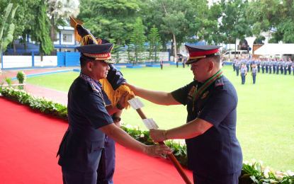 <p><strong>NEW CHIEF.</strong> Outgoing Police Regional Office 10 (Northern Mindanao) Director, Brig. Gen. Lawrence Coop (right), gives the coat of arms of Camp Alagar to the new acting Director, Brig. Gen. Ricardo Layug Jr., during a change of command in Cagayan de Oro City on Tuesday (Oct. 10, 2023). Layug's first day was met with a highway shooting incident in Gingoog City, Misamis Oriental, which occurred four hours before the turnover ceremony. <em>(Photo courtesy of PRO-10)</em></p>