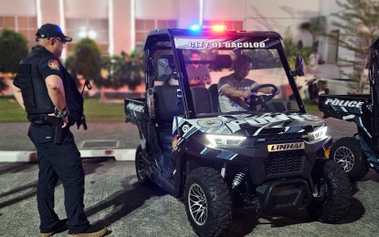 <p><strong>ATV DEPLOYMENT</strong>. Col. Noel Aliño (left), police city director, looks on as Mayor Alfredo Abelardo Benitez checks out the gears of one of the three all-terrain vehicles donated by the city government to the Bacolod City Police Office on Tuesday (Oct. 10, 2023). The ATVs are used to enhance mobility, improve response time and increase police visibility for the ongoing 44th MassKara Festival, which runs until Oct. 22. <em>(Photo courtesy of Bacolod City Police Office)</em></p>