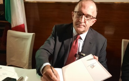 <p><strong>RISING TOGETHER.</strong> Italian Ambassador to the Philippines Marco Clemente signs a copy of the book “Philippine-Italy: Rising Together” during the media launch on Oct. 12, 2023. He said the relationship between Italy and the Philippines is expected to further flourish in the years to come due to the two states’ deep people-to-people connection that spans decades if not centuries. <em>(PNA photo by Joyce Rocamora)</em></p>