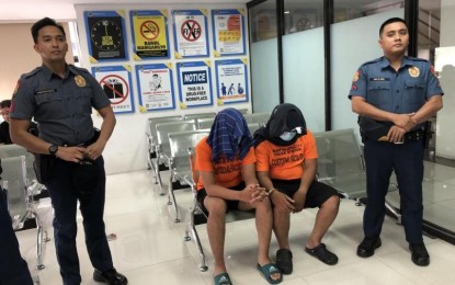 <p><strong>CAUGHT.</strong> An active cop and another police officer declared absent without official leave (AWOL) are in the custody of the Muntinlupa City Police after being caught in a buy-bust operation before midnight on Oct. 11, 2023. The cops will be charged with illegal possession of drugs and firearms. <em>(Photo courtesy of NCRPO)</em></p>