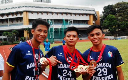 <p><strong>TRIPLE-GOLD WINNER.</strong> Kent Francis Jardin (center) with teammates Jhon Mark Martir (left) and John Yuri Jumaday during the awarding ceremony of the ROTC Games NCR leg at the PhilSports track and field stadium in Pasig City on October 11, 2023. Jardin hopes to keep his winning form in the National Finals scheduled from October 22-27 at the Rizal Memorial Sports Complex. <em>(Contributed photo)</em></p>