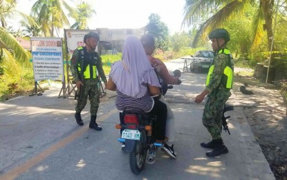 <p><strong>INTENSIFIED CHECKPOINT.</strong> Members of North Cotabato 4th Maneuver Platoon of 2nd Police Provincial Mobile Force Company at a checkpoint in Barangay Ladtingan, Pikit, North Cotabato, following an ambush that killed two junior high students. Pikit is among the towns closely watched by the police ahead of the Barangay elections due to previous election-related violence.<em> (Photo courtesy of Pikit MPS)</em></p>