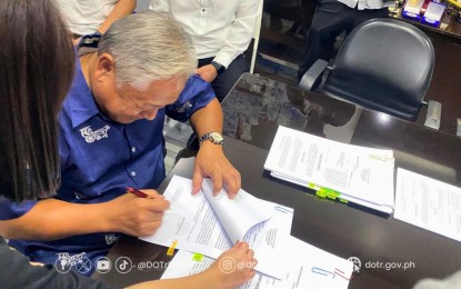 <p><strong>COMPLAINTS FILED.</strong> Department of Transportation Secretary Jaime Bautista signs a complaint he filed against those who accused him of being involved in corruption at the DOTr and the Land Transportation Franchising and Regulatory Board (LTFRB) on Tuesday (Oct. 17, 2023). The cyber libel complaints were filed against Malayang Alyansa ng Bus Employees at Laborers president Mar Valbuena and journalist Ira Panganiban. <em>(Photo courtesy of DOTr)</em></p>