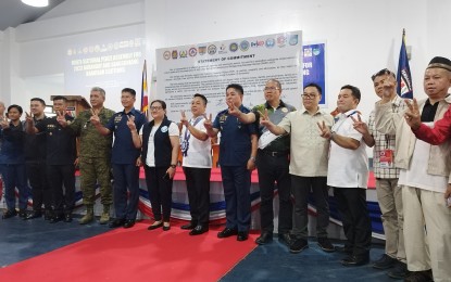 <p><strong>COOPERATION</strong>. Representatives of various national government agencies, and civic and volunteer groups from the province of Pangasinan pose for a photo during the multi-sectoral assembly for the Barangay and Sangguniang Kabataan Elections 2023 at the Magilas Hall of the Pangasinan Police Provincial Office in Lingayen, Pangasinan on Tuesday (Oct.17, 2023). The attendees took their oath of commitment and signed a pledge to support the goal of a safe, credible, and peaceful BSKE. <em>(PNA photo by Hilda Austria)</em></p>