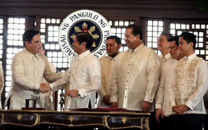 <p><strong>MAHARLIKA INVESTMENT FUND.</strong> President Ferdinand R. Marcos Jr. shakes hands with Senate President Juan Miguel Zubiri after the signing of Republic Act No. 11954 establishing the Maharlika Investment Fund (MIF) last July 18, 2023. The Department of Finance on Monday (Nov. 13, 2023) expressed support for the revised Implementing Rules and Regulations of the MIF Act, noting that the enhancements are within the bounds of the law. <em>(PNA photo by Rolando Mailo)</em></p>