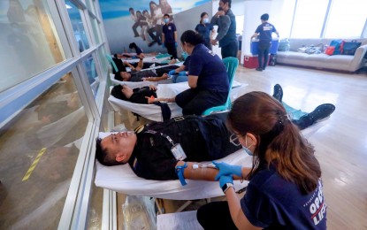 <p><strong>GIFT OF LIFE.</strong> Security personnel of the Presidential Communications Office join a bloodletting drive at the Times Plaza Building in Manila on Oct. 19, 2023. The Philippine Red Cross on Wednesday (Dec. 20, 2023) called on the public to donate blood as donations decline during the festive season while urgent demand for it increases due to more road accidents. <em>(PNA photo by Yancy Lim)</em></p>