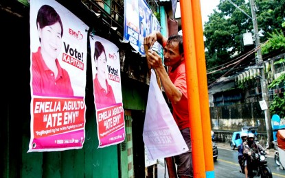 <p><strong>CAMPAIGN IS ON. </strong>A man places a a campaign poster of a candidate  for the Barangay and Sangguniang Kabataan Elections (BSKE) 2023 in front of a private residence in Barangay Tumana, Marikina City on Thursday (Oct. 19, 2023). The Comelec reminded aspirants to follow the guidelines, including the size of the campaign posters and designated common poster areas. <em>(PNA photo by Ben Briones)</em></p>