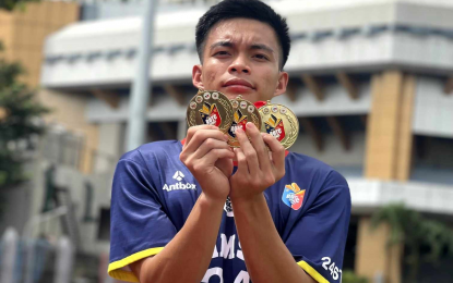 <p><strong>ON TARGET.</strong> Adamson University's Kent Francis Jardin shows the three gold medals he won during the NCR leg of the ROTC Games at the PhilSports track and field stadium in Pasig City in this undated photo. He won the 200m and 4x100m in the National Championships at the PhilSports on Monday (Oct. 23, 2023. <em>(Contributed photo)</em></p>