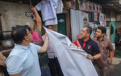 <p><strong>OPERATION BAKLAS.</strong> Commission on Elections (Comelec) Chairperson George Erwin Garcia leads a takedown of illegal campaign materials at the Maricaban area in Pasay City on Tuesday (Oct. 24, 2023). He said the poll body has begun issuing show cause orders for illegal campaigning after it launched its Operation Baklas on Friday. <em>(PNA photo by Yancy Lim)</em></p>