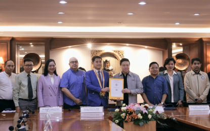 <p><strong>CLIMATE INNOVATION.</strong> Climate Change Commission Vice Chairperson and Executive Director Robert E.A. Borje (5th from left) and University of Santo Tomas (UST) Rector and President Fr. Richard Ang (4th from right) hold the cooperation agreement for climate innovation and sustainability that they signed in UST, Manila on Oct. 17, 2023. The collaboration will also serve as a platform for sustainable entrepreneurship, fostering collaborations and initiatives that will promote environmentally conscious business practices. <em>(Photo courtesy of CCC)</em></p>