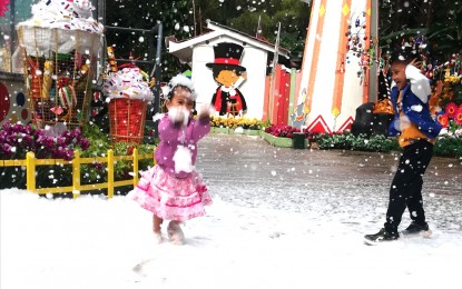 <p><strong>SNOW SHOW</strong>. A little girl enjoys the snow show at the Baguio Country Club Christmas Village on Oct. 21, 2023. The snow show along with the re-enactment of the Nativity scene are among the main attractions in the Village with this year's them of  “World of Fun”.<em> (PNA photo by Liza T. Agoot)</em></p>