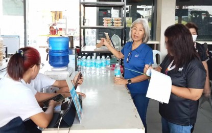 <p><strong>‘BANTAY PRESYO’.</strong> Nimfa Virtucio (in blue shirt), provincial director of the Department of Trade and Industry in Negros Oriental, inspects a business establishment on Thursday (Oct. 26, 2023) in line with Oplan Bantay Presyo Undas 2023. The agency monitors the possible increase in prices of bottled water, candles and flowers as the observance of All Saints' and All Souls’ Days nears. (<em>Photo courtesy of DTI-Negros Oriental)</em></p>