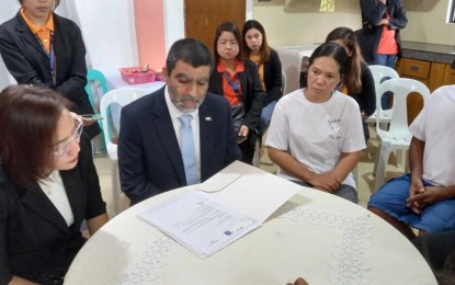 <p><strong>ASSISTANCE FROM ISRAELI EMBASSY</strong>. Israeli Consul Moti Cohen (center), with Overseas Workers Welfare Administration-Western Visayas OIC-Regional Director Rizza Joy Moldes (left), visits the family of slain Negrense caregiver Loreta Alacre at her wake in her hometown of Cadiz City, Negros Occidental on Thursday (Oct. 26, 2023). Cohen brought a letter from the Israeli Ambassador to the Philippines Ilan Fluss, who extended his deepest sympathy and condolences to the family for their loss and assured the Alacre family that the Israel Embassy in Manila would help facilitate their claims for benefits from the Israel Social Security Institute. (<em>Photo courtesy of Local Government Unit-Cadiz City</em>)</p>
