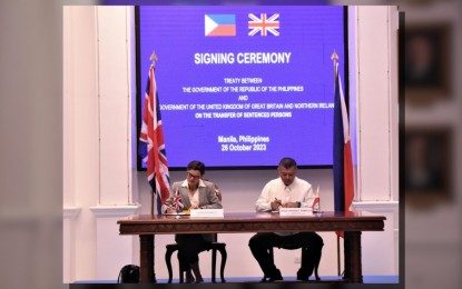 <p><strong>TREATY.</strong> Department of Justice (DOJ) Secretary Jesus Crispin C. Remulla (right) and United Kingdom Ambassador to the Philippines Laure Beaufils sign the PH-UK Treaty on the Transfer of Sentenced Persons at the DOJ Justice Hall in Manila on Thursday (oct. 26, 2023). The signing of the treaty further strengthens bilateral relations between the Philippines and the UK. <em>(Photo courtesy of DOJ)</em></p>