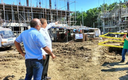 <p><strong>HOUSING PROJECT</strong>. Former senator Franklin Drilon (second from left) inspects on Oct. 19, 2023 the housing project at the Uswag Residential Complex in Barangay San Isidro, Jaro District in Iloilo City which funding he facilitated before he stepped down from the Senate. In an interview on Friday (Oct. 27, 2023), lawyer Peter Jason Millare, head of the Iloilo City Local Housing Office, said a huge housing backlog is a challenge for the city government<em>. (PNA file photo by PGLena)</em></p>