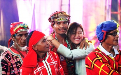 <p><strong>ONE WITH GOVERNMENT.</strong> Arian Jane Ramos, former Guerilla Front 55 Secretary of the New People's Army (NPA) also known as "Marikit" (2nd from right), hugs Datu Tungig Mansumuy-at, a former spokesperson of the Pasakaday Salugpongan Kalimodan (PASAKA) - Southern Mindanao Region and former party member of the Communist Party of the Philippines (CPP), during the first anniversary celebration of an Insurgency-Free Davao Region in Davao City on Oct. 28, 2023. The two are urging other remnants of the NPA to return to the folds of the law and embrace lasting peace. <em>(Photo from 10ID)</em></p>