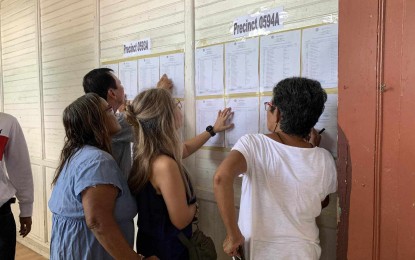 <p><strong>SUCCESSFUL.</strong> Voters locate their names in the master list in a polling center at the La Paz 1 Elementary School during Monday’s (Oct. 30, 2023) Barangay and Sangguniang Kabataan Elections. Regional Elections Director Dennis Ausan, in an interview, credited the peaceful and successful elections to the support of all stakeholders in Western Visayas. <em>(Contributed photo)</em> </p>