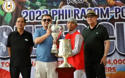 <p><strong>WINNER AGAIN.</strong> Jockey Dan "The Jackhammer" Camañero (2nd from right) receives his trophy from Philippine Charity Sweepstakes Office (PCSO) General Manager Mel Robles after his victory atop Boss Emong in the Philracom-PCSO Silver Cup on Sunday (Oct. 29, 2023). Looking on are Philippine Racing Commission (Philracom) Chairman Reli de Leon (right) and PCSO Director Felix Reyes. <em>(Philracom photo)</em></p>