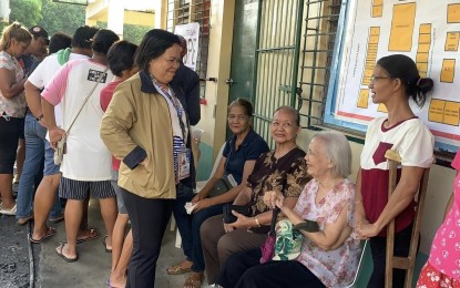 <p><strong>VOTER REGISTRATIONS</strong>. Commission on Elections (Comelec) regional director for Bicol, lawyer Maria Juana Valeza (in brown jacket), chats with elderly voters at Rawis Elementary School in Legazpi City in this Oct. 30, 2023 photo. Valeza on Tuesday (May 7, 2024) said they have accepted 110,582 various types of applications since the start of voter registration from Feb. 12 to May 4 this year.  <em>(Photo from Maria Juana Valeza's Facebook page)</em></p>