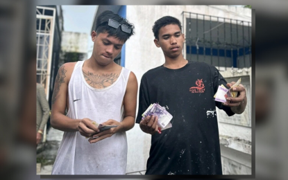 <div dir="auto"><strong>UNDAS LIVELIHOOD</strong>. Two young men from Bacolod City, “Bornok” and “Waldo”, show the money they made from providing graveyard cleaning services at the city’s largest public cemetery located on Burgos Street in Barangay Villamonte on Tuesday (Oct. 31, 2023). Other enterprising Bacolodnons, including children, also earn from similar services they provide in other public cemeteries during the All Saints’ Day on Wednesday (Nov. 1, 2023). <em>(Photo courtesy of Adrian Prietos)</em></div>