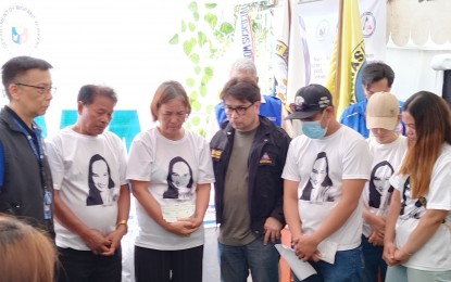 <p><strong>HEROINE'S WELCOME.</strong> The family of Angelyn Aguirre is comforted by Department of Migrant Workers Officer-in-Charge Undersecretary Hans Leo Cacdac (left) and Overseas Workers Welfare Administration deputy administrator Arnaldo Ignacio (center) at her wake in Binmaley, Pangasinan on Saturday (Nov. 4, 2023). Aguirre was an overseas Filipino worker who was killed by Hamas militants in Kibbutz Kfar Aza, Israel on Oct. 7 when the conflict started. <em>(PNA photo by Hilda Austria)</em></p>