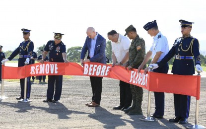 <p><strong>EDCA PROJECT.</strong> Defense Secretary Gilberto Teodoro Jr. (4th from right) and US Deputy Chief of Mission to the Philippines Robert Ewing (3rd from left) lead the ribbon cutting and blessing of the rehabilitated runway of the Basa Air Base in Floridablanca, Pampanga on Monday (Nov. 6, 2023). This is the largest Enhanced Defense Cooperation Agreement (EDCA) project between the Philippines and the United States which amounts to over PHP1.3 billion. <em>(Photo courtesy of the PAF)</em></p>