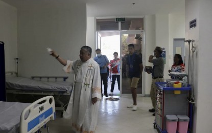 <p><strong>NEW BUILDING</strong>. Fr. Leonardo Ruiz blesses the new building of the Piddig District Hospital on February 27, 2023. A newborn hearing screening machine will soon be available in this hospital courtesy of the Department of Health. <em>(File photo courtesy of Piddig LGU)</em></p>