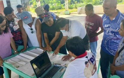 <p><strong>DEBT CONDONATION</strong>. Personnel of the Department of Agrarian Reform-Ilocos Norte examine documents submitted by farmers in Barangay Pasaleng, Pagudpud, Ilocos Norte on Monday (Nov. 6, 2023) for the validation of landholdings subject for condonation of agrarian debt. DAR is rolling out a condonation response desk to facilitate the issuance of condonation certificates to eligible beneficiaries. <em>(Photo courtesy of DAR Ilocos Norte)</em></p>