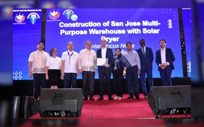 <p><strong>POST-HARVEST FACILITY</strong>. Vintar Mayor Richard Degala (5th from left) receives a certificate of award for the construction of warehouse and solar dryer in Vintar, Ilocos Norte. The PHP11.9-million infrastructure is expected to benefit nearly 500 farmers, lessening farmers’ post-harvest losses and increasing their productivity. <em>(Photo from the Office of Vintar Mayor Richard Dagala)</em></p>