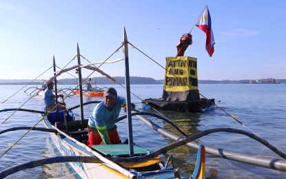<p><strong>OURS.</strong> A group of fisherfolk releases an 18-foot symbolic buoy bearing the Philippine flag and a large “Atin ang Pinas!” (The Philippines is Ours) sign off the waters of Barangay San Salvador, Masinloc, Zambales on Nov. 6, 2023. The Department of Foreign Affairs denounced Sunday (May 26, 2024) China’s threat to detain for a maximum 60 days without trial perceived foreign trespassers who will cross what it claims are its borders. <em>(PNA file photo)</em></p>