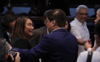 <p><strong>APPROVED</strong>. Senate President Juan Miguel Zubiri greets Presidential Communications Office Secretary Cheloy Garafil (left) on Monday (Nov. 13, 2023) after the approval of the agency's PHP2.467 billion proposed budget for 2024. Garafil said senators realized the importance of the agency's mandate, especially information dissemination and fighting fake news. <em>(PNA photo by Avito Dalan)</em> </p>
