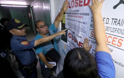 <p><strong>PADLOCKED</strong>. Personnel of the Department of Migrant Workers (DMW) and the Manila Police District padlock the firm Double D Training Consultancy Services in Sta. Cruz, Manila on Tuesday (Nov. 14, 2023). The DMW said the consultancy firm is not authorized to recruit seafarers. <em>(PNA photo by Yancy Lim) </em></p>